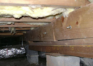 sagging crawl space with wooden shimming a Potomac crawl space