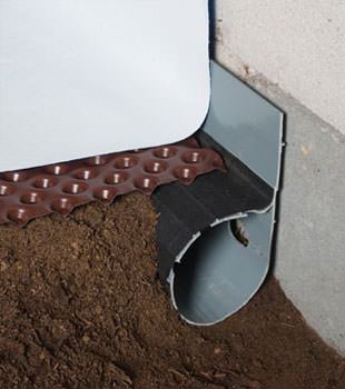 Closeup of a crawl space drainage system installed in Culpeper