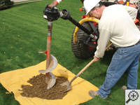 Auguring a hole in the earth for a foundation repair in Gaithersburg