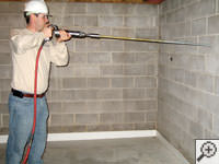 Coring a one inch hole in a foundation wall to allow for the earth anchor rod to pass through.