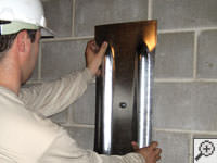 Mounting a foundation wall plate for an earth anchor installation in Germantown.