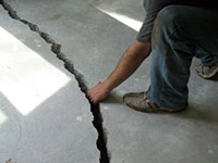 a severely damaged cracked concrete slab floor in Christiansburg