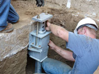 Foundation repair contractors installing the foundation bracket in Frederick.