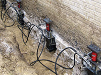 Using foundation push piers to lift a foundation during a repair in Rockville.