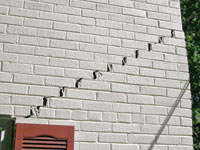 Stair-step cracks showing in a home foundation in Culpeper