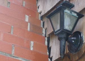 A tilting chimney in Harrisonburg showing serious foundation damage.