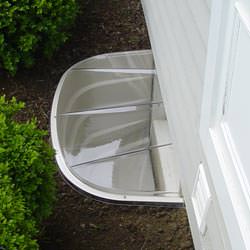 A vinyl basement window and covered window well in Waynesboro
