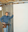 Installing wall panels on top of our basement wall insulation in Silver Spring